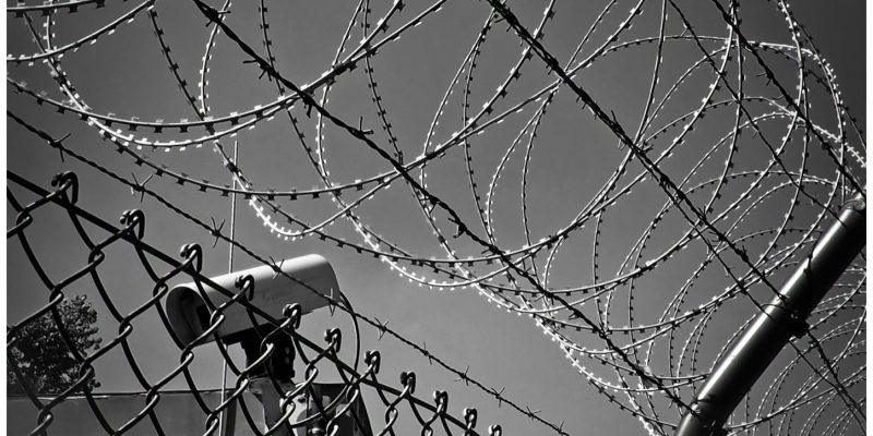 barbed wire and surveillance camera